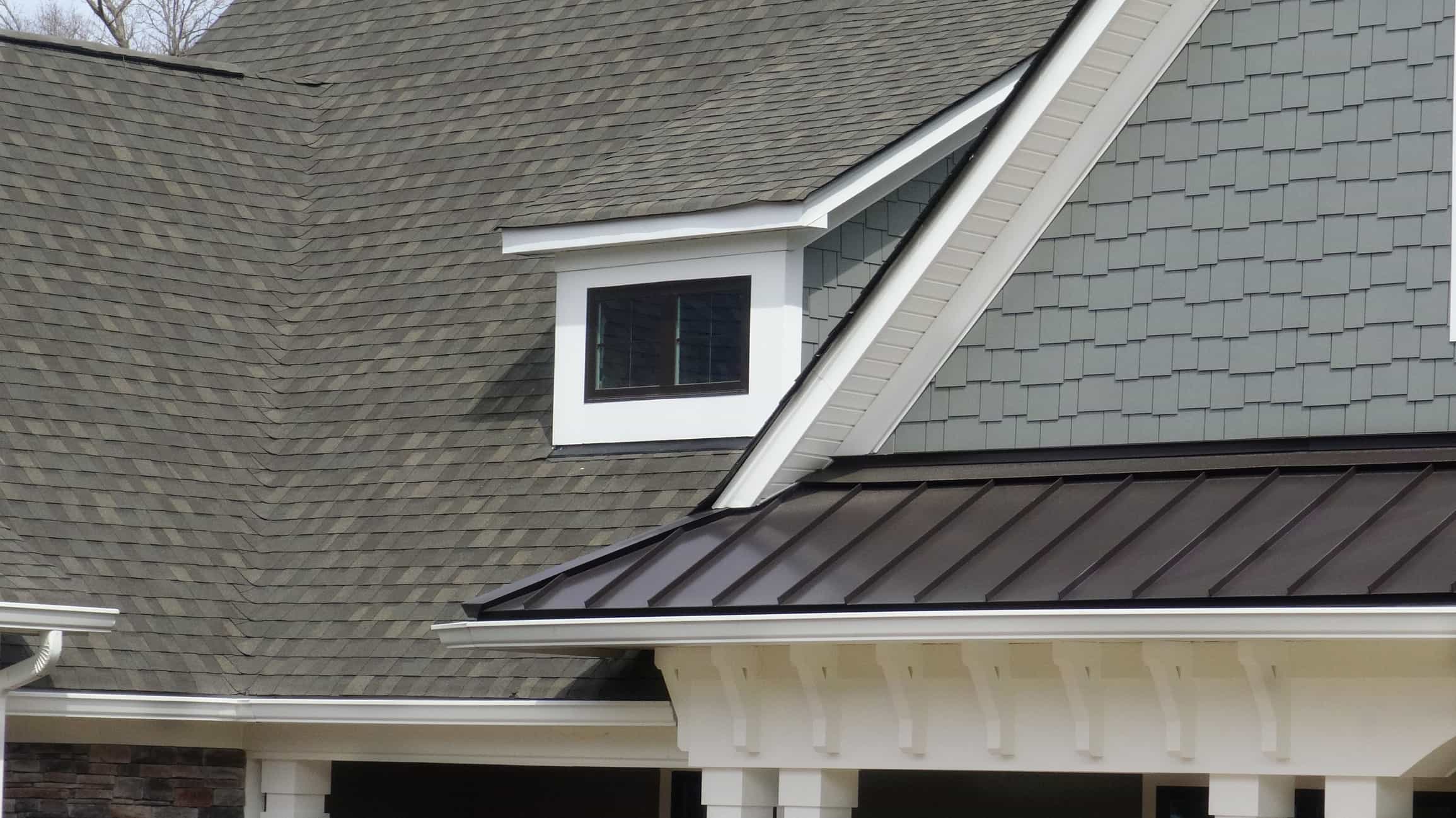 House with metal and asphalt shingle roof